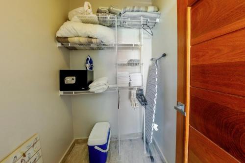 a bathroom with a closet with a toilet and towels at Corte Sea A302, Luxury Penthouse in Punta Cana