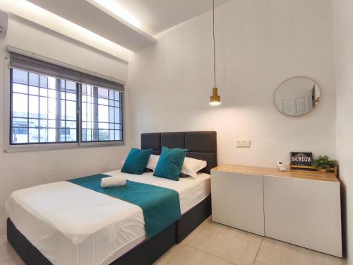a bedroom with a large bed and a mirror at Merdeka One Homestay 8pax 4Rooms in Sibu