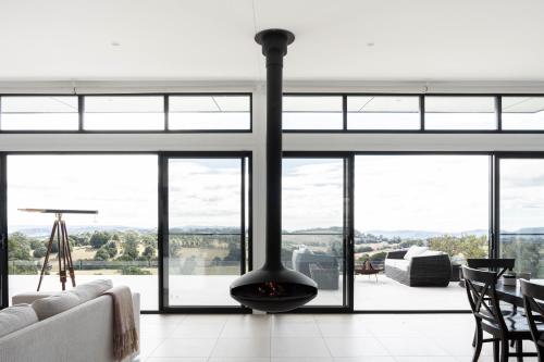 a living room with a fireplace and glass windows at Beechmont Estate in Beechmont