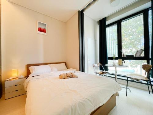 a bedroom with a bed with two shoes on it at 엠지스테이 서면 Mzstay Modern Hotel in Seomyeon in Busan