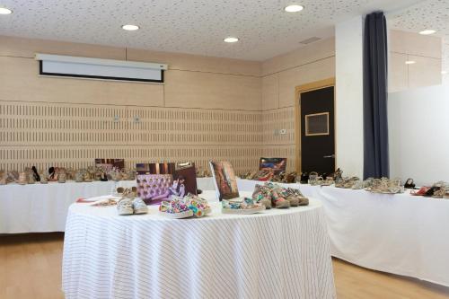 a table with a white table cloth with shoes on it at Daniya Alicante in Alicante