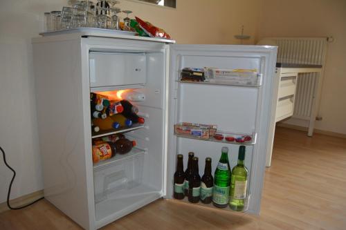 a white refrigerator with its door open with drinks at B&B Prosterath-Hochwald in Prosterath