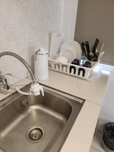 a kitchen counter with a sink and a sink at Manhattan Condominium Ipoh in Ipoh