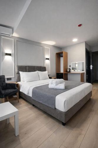 a bedroom with a large bed and a chair at Olen Uskudar Hotel in Istanbul