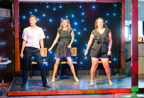 a group of three people standing on a stage at Pavlo Napa Beach Hotel in Ayia Napa