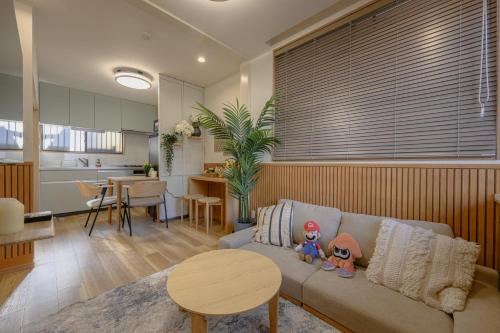 a living room with a couch with two stuffed animals on it at Direct Haneda Access &Onsen 1-min Walk SAMURAI STAY ZEN in Tokyo