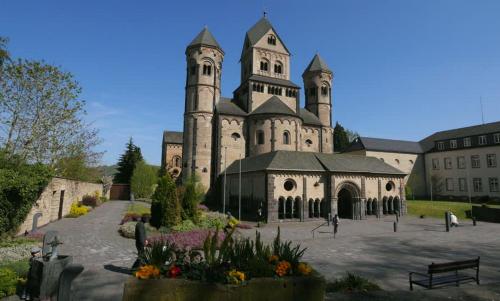 a large building with a church with a clock tower at City Apartment Mendig in Mendig