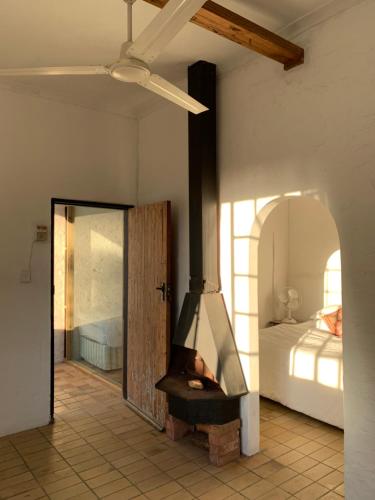 a fireplace in a room with a bedroom at The Barn, at Glenora Avenue in Somerset West