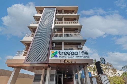 a treehouse building with a sign on it at Treebo Himalayan Homestay in Pune