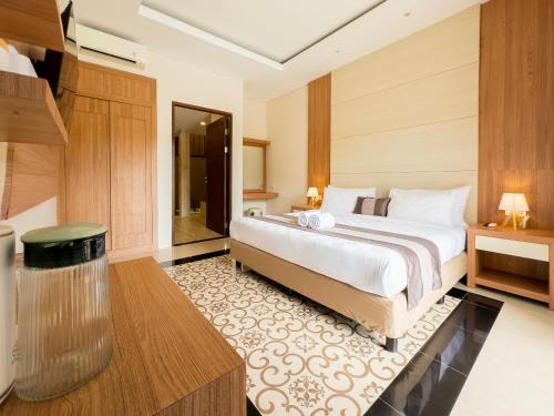 a bedroom with a large bed in a room at Airindah Villa in Gili Islands