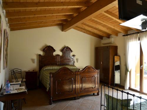 sypialnia z drewnianym łóżkiem w pokoju w obiekcie 9 Muse Bed and Breakfast w mieście Canneto sullʼOglio