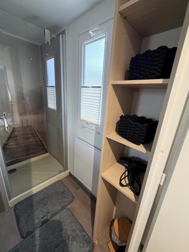 a bathroom with a walk in shower next to a walk in shower at Seacottage Blankenberge-Wenduine in De Haan