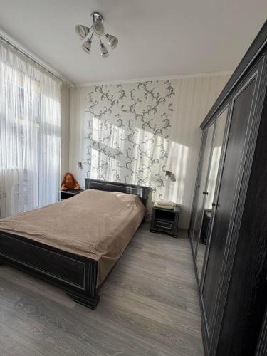 a bedroom with a bed and a ceiling fan at Центр.Леся Українка in Lutsk