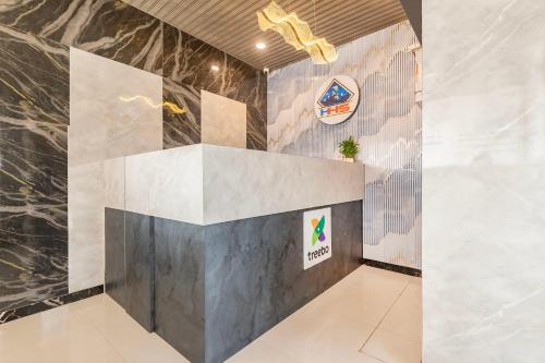 a lobby with a wall with a logo on it at Treebo Himalayan Homestay in Pune