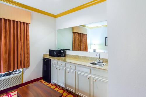 a kitchen with a sink and a microwave at Quality Suites Lubbock Southwest in Lubbock