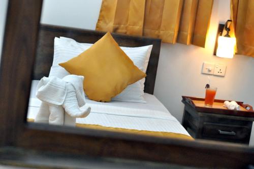 a reflection of a bed with a stuffed elephant on it at Green View Safari Resort in Udawalawe