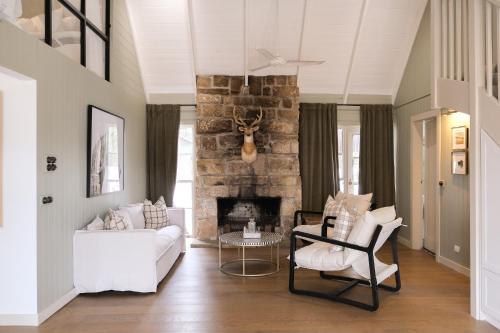 a living room with a white couch and a fireplace at The Station Hunter Valley in Pokolbin