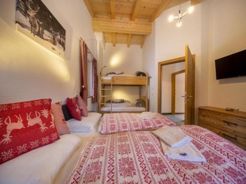 a bedroom with a large bed and a tv at Mountain Wellness stay in Neukirchen in Neukirchen am Großvenediger