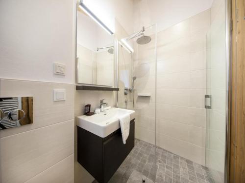 a white bathroom with a sink and a shower at Mountain Wellness stay in Neukirchen in Neukirchen am Großvenediger