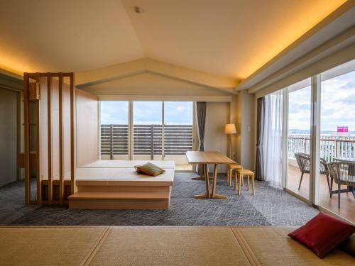 a hotel room with a bed and a large window at TATAMI NO YADO Chatan Mihama by COLDIO in Chatan
