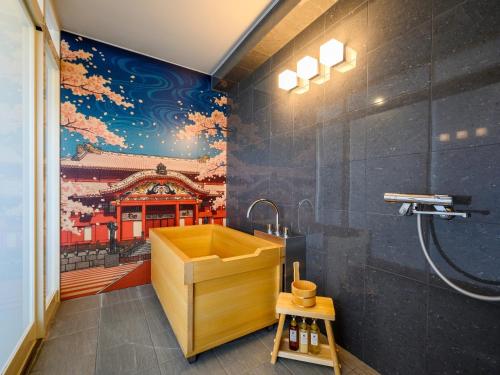 a bathroom with a sink and a painting on the wall at TATAMI NO YADO Chatan Mihama by COLDIO in Chatan