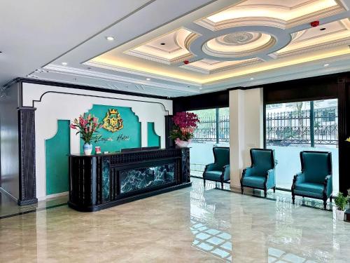 a lobby with a fireplace and two blue chairs at Royal Hotel Lâm Hạ in Hanoi