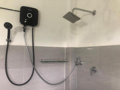 a shower with a camera on the wall in a bathroom at Diamond Mount Villa in Dambulla