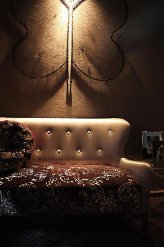a room with a couch and a light on the wall at L'Alcazar in Rabat