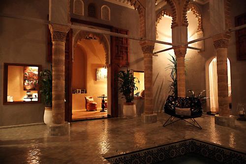 a lobby with a pool in the middle of a building at L'Alcazar in Rabat