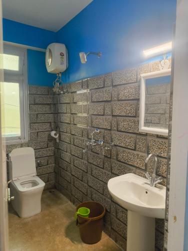 a bathroom with a toilet and a sink at Mayal Lyang Lachung in Mangan