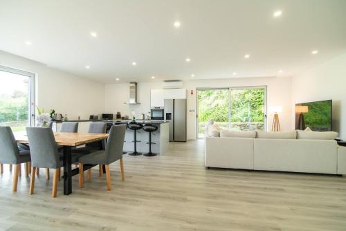 a kitchen and living room with a table and a couch at Seaview Villa with Heated Private Pool in Bretanha