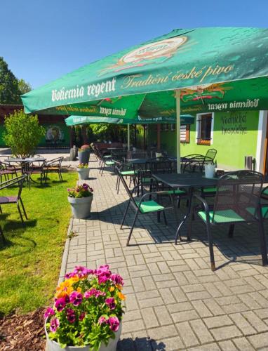 a restaurant with tables and chairs and flowers at Penzion u Vodníka in Třeboň
