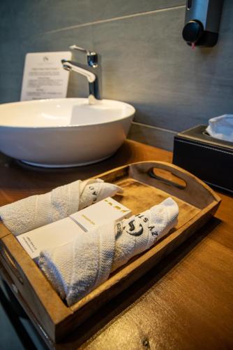 a wooden tray with a sink and a towel at Cozy Stead Hotel - Garden House, Gigiri in Nairobi