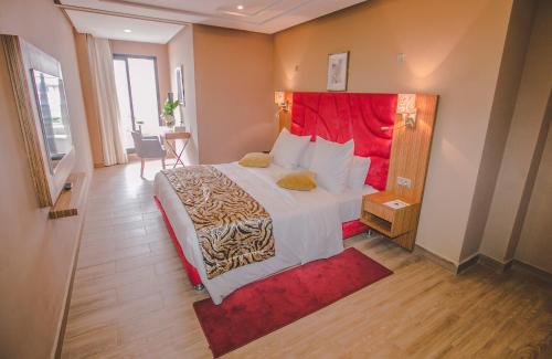 a bedroom with a large bed with a red headboard at DownTown Hotel By New Art in Casablanca