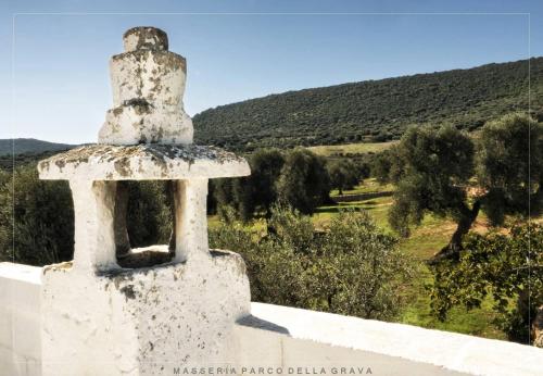 a stone tower on top of a building with a view at Masseria Parco della Grava in Pezze di Greco
