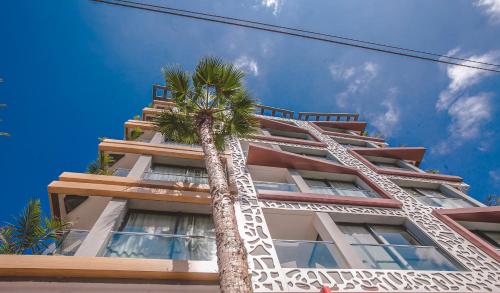 a palm tree in front of a building at Hôtel Down Town Maarif in Casablanca