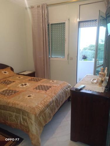 a bedroom with two beds and a window with a window at appartement 1 centre ville in Kenitra