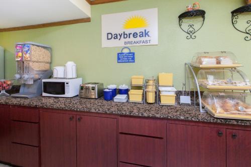 a kitchen with a counter with a microwave on it at Days Inn & Suites by Wyndham Madison Heights MI in Madison Heights