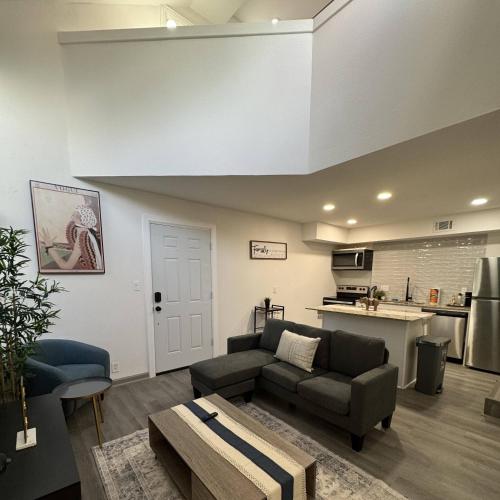 a living room with a couch and a table at 2BD DT Dallas l FIFA READY l 5 Min from Love Field in Dallas