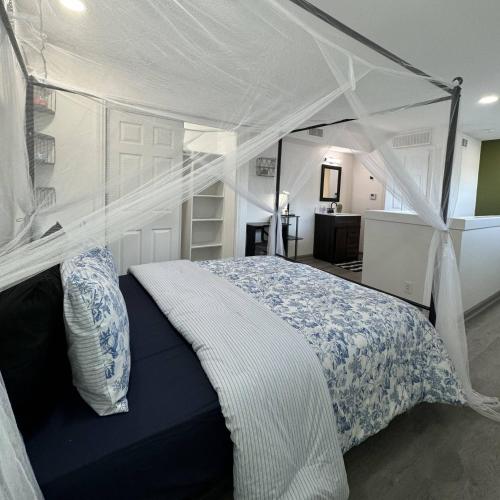 a bedroom with a bed with a canopy at 2BD DT Dallas l FIFA READY l 5 Min from Love Field in Dallas