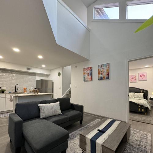a living room with a couch and a table at 2BD DT Dallas l FIFA READY l 5 Min from Love Field in Dallas