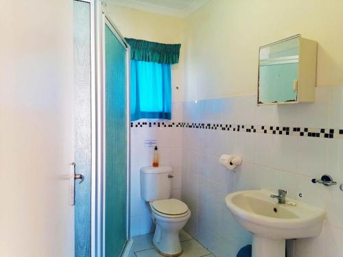 a bathroom with a toilet and a sink at All the Tides - Rip Tide in Margate