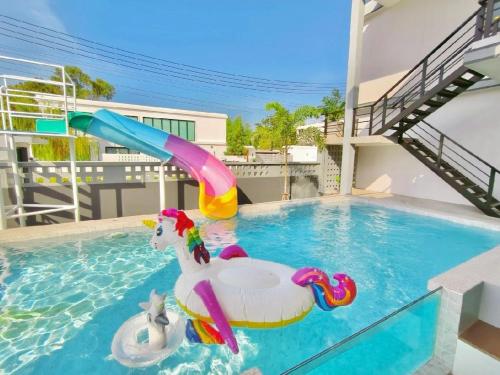 a pool with a inflatable unicorn in the water at Pool villa Cream Darin in Ban Hua Phrong