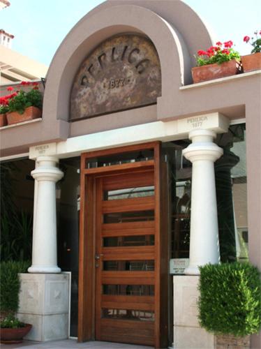 a entrance to a building with a wooden door at Room and Apartment Perlica in Klis