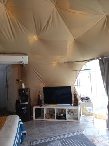 a living room with a tent with a tv in it at Sangkuriang 1 - Private Dome in Bandung