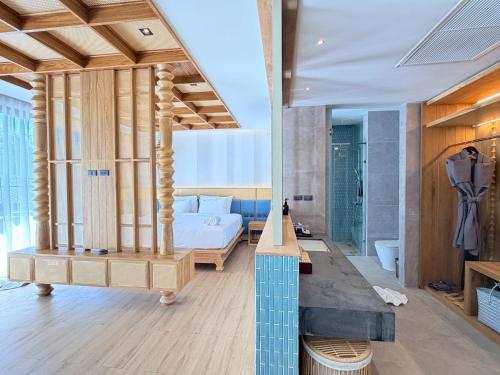 a master bedroom with a bed and a bathroom at Ananya Lipe Resort in Ko Lipe
