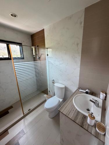 a bathroom with a toilet and a sink at Phratamnak Grand Apartments - Cozy Beach in Pattaya South