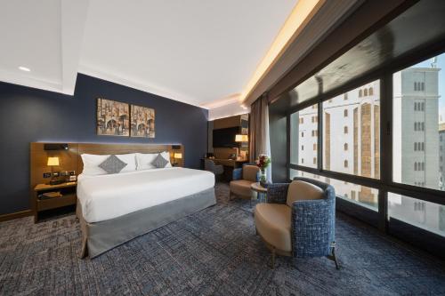 a hotel room with a bed and a large window at MADEN Taiba HOTEL in Medina