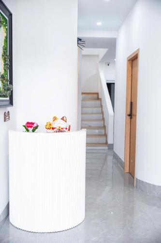 a white counter in a room with stairs at BY Home in Hue