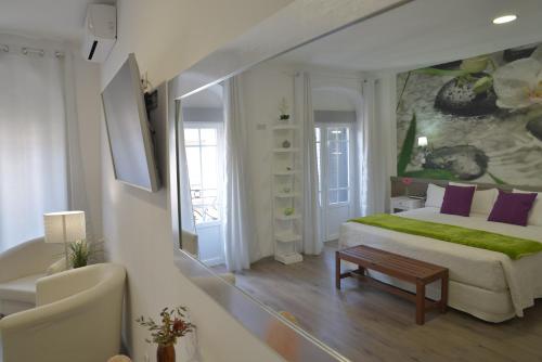 a bedroom with a bed and a living room at Hostal Madrid Star in Madrid